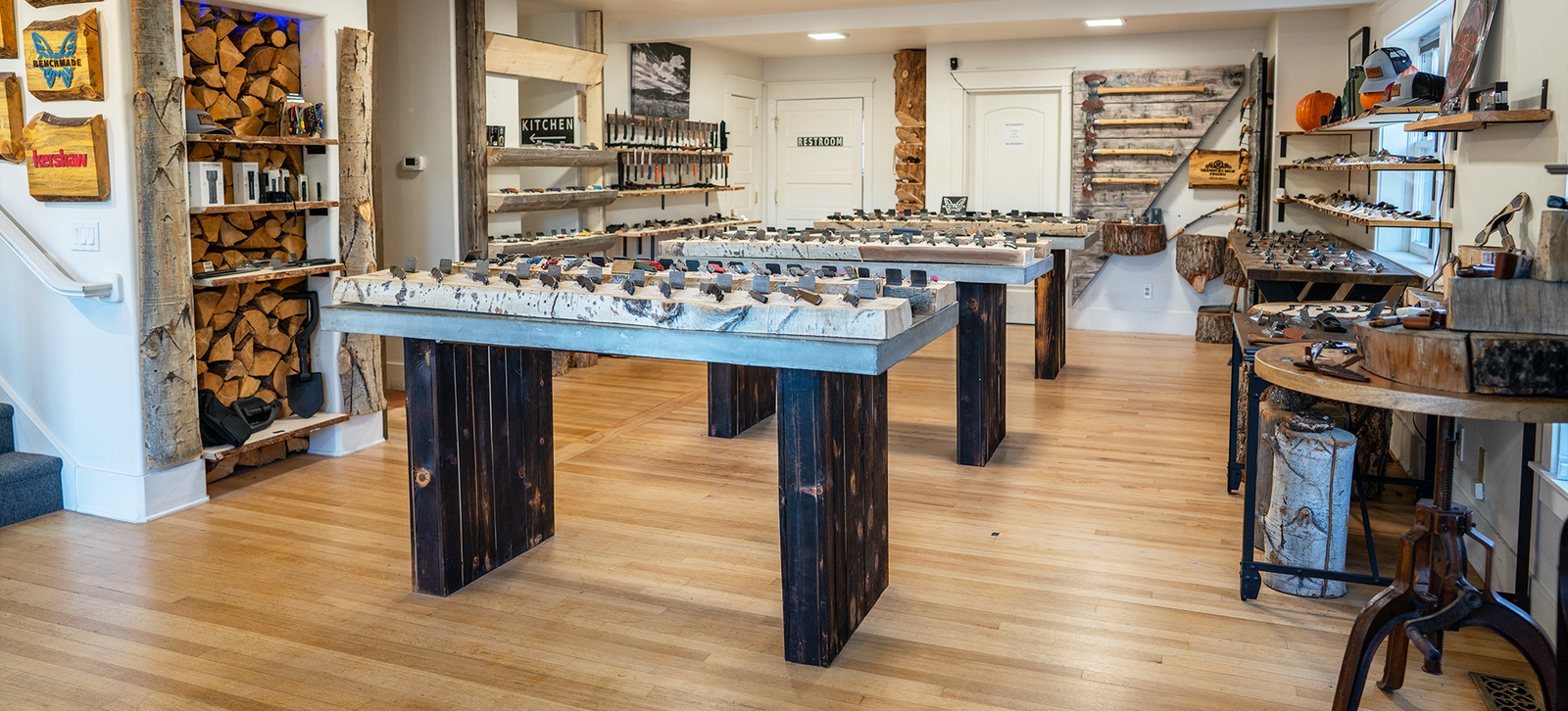 Inside the Timber Knives showroom, knives laid out in rows across a long display table