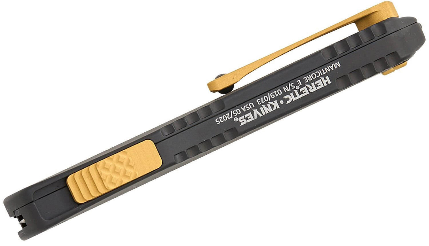 Heretic Knives Manticore E OTF AUTO Knife showing black grip and gold clip, featuring sleek design and precision craftsmanship.